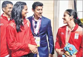  ??  ?? Sports Minister Rajyavardh­an Singh Rathore with gold medalist Saina Nehwal, silver medalist PV Sindhu and coach P Gopichand during the Commonweal­th Games 2018, in Gold Coast on Sunday.