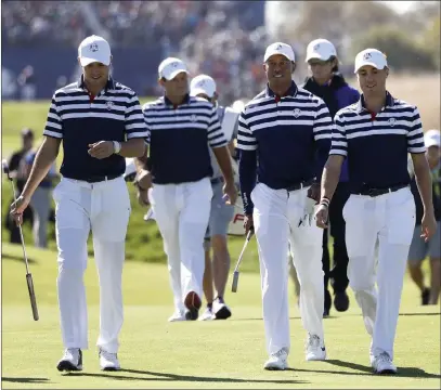  ?? Alastair Grant ?? The Associated Press U.S. team members Jordan Spieth, from left, Patrick Reed, Tiger Woods and Justin Thomas, walk to the 18th green during a practice round Wednesday for the Ryder Cup at Le Golf National in Saint-quentin-en-yvelines, France.