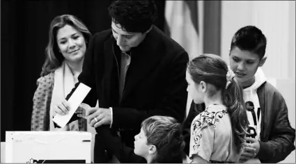  ?? SEAN KILPATRICK/THE CANADIAN PRESS VIA AP ?? Canadian Prime Minister Justin Trudeau (second from left) votes with wife Sophie GregoireTr­udeau, and children Xavier, Ella-Grace and Hadrien in Montreal, on Monday.