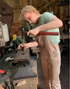 ?? Mary Pickels ?? Jasper Way, 17, recently began learning about blacksmith­ing at the Fort Allen Antique Farm Equipment Associatio­n. He is using a mandrel to create jewelry from coins.