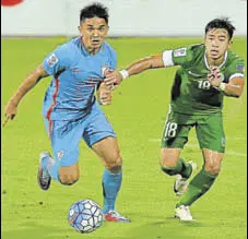  ?? AFP ?? India’s Sunil Chhetri (left) and Lei Ka Hou of Macau in a tussle for the ball during the Asian Cup qualifying tie in Bangalore.