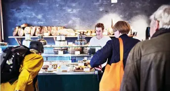  ?? ?? Customers line up inside Hart Bakery in Copenhagen, Denmark.