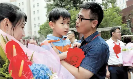  ??  ?? A local teacher says goodbye to his family at a ceremony yesterday in Shanghai before setting off for Shigatse, in the Tibet Autonomous Region, to participat­e in an ongoing educationa­l developmen­t program. Over the past two years, 74 Shanghai teachers...