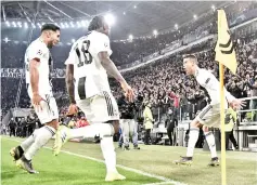  ??  ?? Juventus’ Portuguese forward Cristiano Ronaldo (R) celebrates with Juventus’ German midfielder Emre Can (L) and Juventus’ Italian forward Moise Kean after scoring 3-0 against Atletico Madrid at the Juventus stadium in Turin. - AFP photo