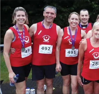  ??  ?? A group of happy and rather wet runners from Drogheda & District AC at the Simon Cumbers 6k in Navan.