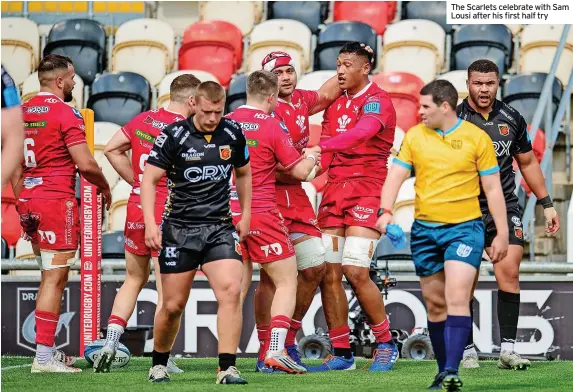  ?? The Scarlets celebrate with Sam Lousi after his first half try ??