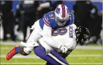  ?? JOHN MUNSON/ASSOCIATED PRESS ?? Bills defensive end Mario Addison (top) sacks Ravens quarterbac­k Lamar Jackson during the first half Saturday night in Orchard Park, N.Y. Jackson later suffered a concussion.