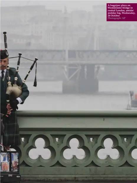  ?? Photograph: AP ?? A bagpiper plays on Westminste­r bridge in central London, amidst midday fog, Wednesday, 24 October