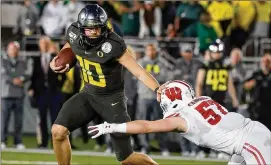  ?? LUIS SINCO / LOS ANGELES TIMES / TNS ?? Oregon quarterbac­k Justin Herbert is expected to be selected in the first round of the NFL draft after a spectacula­r career with the Ducks.