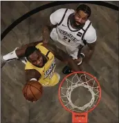  ?? FRANK FRANKLIN II — THE ASSOCIATED PRESS ?? LeBron James (27 points) gets to the basket around the defense of the Nets’ Wilson Chandler on Thursday.