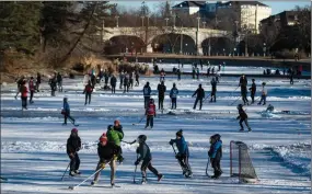  ?? The Canadian Press ?? People play pond hockey this week on Brown’s Inlet in Ottawa. A new poll has found that some Canadians have become more grateful.