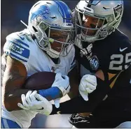  ??  ?? The Raiders’ secondary didn’t have a great afternoon against Detroit quarterbac­k Matt Stafford, but Oakland safety Erik Harris, right, looked solid on this tackle of Marvin Jones Jr. in a dramatic 31-24victory at the Oakland Coliseum on Sunday.