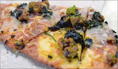  ?? SARAH GORDON/THE DAY ?? A test of pizza dough, topped with sausage and vegetables, is seen as volunteers make pizza dough at RD86 in New London in preparatio­n for Ketofest.