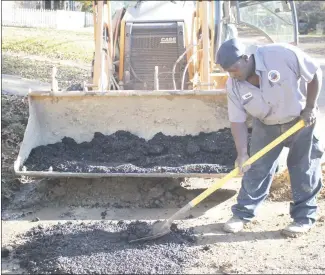  ?? Brodie Johnson • Times-Herald ?? The Forrest City Water Department has been busy making repairs throughout the city as water lines have ruptured. Mike Davis, with the water department, shovels asphalt to patch a section on Dillard Street after repairs were made to a ruptured line.