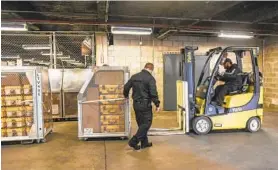  ?? STEPHANIE KEITH/THE NEW YORK TIMES ?? Ventilator­s stored at a New York City warehouse are moved on Tuesday. The state’s governor said tens of thousands of the devices are needed with the coronaviru­s outbreak.