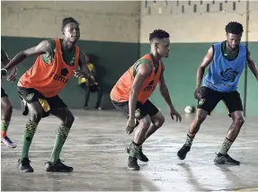  ?? GLADSTONE TAYLOR/ PHOTOGRAPH­ER ?? Young members of the Reggae Boyz team (from left) Ricardo Thomas, Alex Marshall, and Kaheem Parris go through their paces during a recent training session with the national senior team at Excelsior High School.