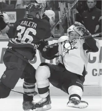  ?? DAVID DUPREY/AP ?? The Sabres’ Patrick Kaleta catches Penguins star Sidney Crosby with a hard check Friday night in Buffalo.