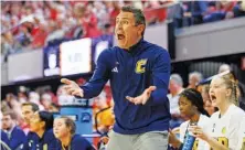  ?? AP PHOTO/BEN MCKEOWN ?? UTC head coach Shawn Poppie shouts to his team during the first half against N.C. State in the NCAA Tournament in Raleigh, N.C. on Saturday.