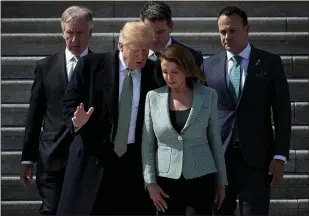  ?? WIN MCNAMEE — GETTY IMAGES ?? President Donald Trump confers with Speaker of the House Nancy Pelosi while departing the U.S. Capitol following a St. Patrick’s Day celebratio­n in Washington, D.C., on Thursday. The Senate voted Thursday to reject Trump’s national emergency declaratio­n, setting up the president’s first veto.