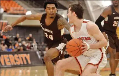  ?? KYLE FRANKO — TRENTONIAN PHOTO ?? Princeton’s Ethan Wright (14) looks to move past Brown’s Desmond Cambridge (24) during an Ivy League game on Friday night.