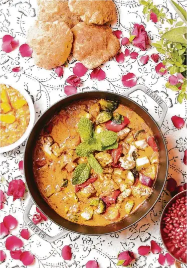  ?? Elizabeth Conley / Staff photograph­er ?? A table set for Diwali includes 7 Vegetable Stew, Persimmon Rice Pudding and Herbed Poori. Chef Anita Jaisinghan­i’s recipes, page D8