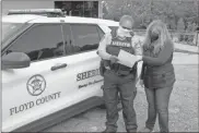  ?? Doug Walker ?? Deputy Miranda Couey (left) checks with Dawn Hayes of the Bagwell Food Pantry to make sure she has everything for a delivery of food from the pantry Thursday.