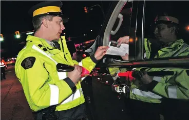  ?? ICBC FILES ?? Police officers will check drivers on B.C.’s roads during the holiday season.
