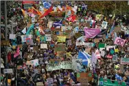  ?? (AP/PA/Andrew Milligan) ?? Climate activists march Friday during a demonstrat­ion in the center of Glasgow, Scotland.