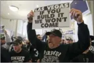  ?? ERIC RISBERG — THE ASSOCIATED PRESS ?? Oakland Raiders fans hold up signs and yell during a rally to keep the team from moving Saturday in Oakland NFL owners are expected to vote on the team’s possible relocation to Las Vegas on Monday or Tuesday at their meeting in Phoenix.