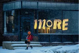  ?? JEFF WHEELER / STAR TRIBUNE VIA AP ?? A child walks home from school in Minneapoli­s in the winter storm that hit the Twin Cities on Tuesday. The storm took aim at the Upper Midwest in a three-day onslaught that could affect more than 40 million Americans.