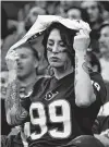  ?? Karen Warren / Staff photograph­er ?? A Texans fan drapes a towel over her head during the second quarter.