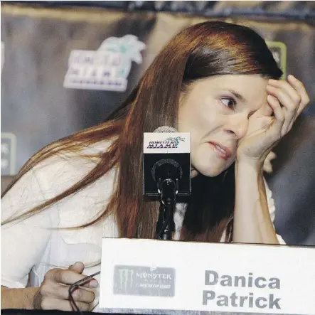  ?? DARRYL GRAHAM/THE ASSOCIATED PRESS ?? Danica Patrick wipes away tears at a conference Friday as she announces she will end her full-time racing career after running in next year’s Daytona 500 and Indianapol­is 500.