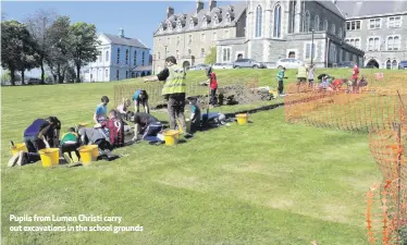  ??  ?? Pupils from Lumen Christi carry out excavation­s in the school grounds