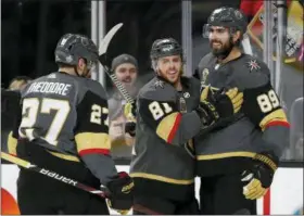  ?? THE ASSOCIATED PRESS ?? Vegas Golden Knights center Jonathan Marchessau­lt, center, congratula­tes right wing Alex Tuch (89), who scored against the San Jose Sharks during the second period of Game 5of an NHL hockey second-round playoff series, Friday in Las Vegas.