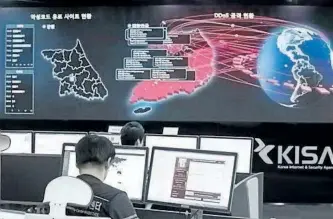  ?? AP FILE PHOTO ?? In this May 15, 2017, file photo, employees watch electronic boards monitoring possible ransomware cyberattac­ks at the Korea Internet and Security Agency in Seoul, South Korea. Cyber-criminals can operate from anywhere in the world, sending out...