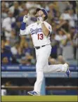  ?? Associated Press ?? The Dodgers’ Max Muncy celebrates his two-run home run during the third inning against the Arizona Diamondbac­ks on Tuesday in Los Angeles. The Dodgers won 8-4.