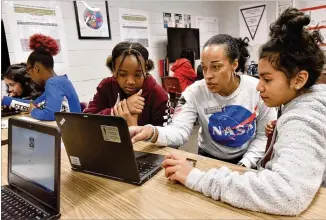  ?? PHOTOS BY HYOSUB SHIN / HYOSUB.SHIN@AJC.COM ?? Sweetwater Middle School teacher Shana White works on a computer along with students Victorine Gamon, 12, (left) and Nicole Montoya, 11. Students in White’s sixth grade computer science class wanted to use real-world data in testing formulas and applicatio­ns.