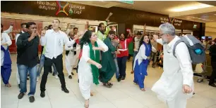  ??  ?? A passenger joins the flashmob at the Abu Dhabi airport as part of the Independen­ce Day celebratio­ns.