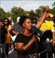  ?? LUIS SANTANA/TAMPA BAY TIMES VIA AP ?? In this Sunday, photo, Ruth Beltran, of Black Lives Matter Tampa, speaks to the crowd about standing up for the rights of black people in the community as family, friends and demonstrat­ors gather in a parking lot in Clearwater.