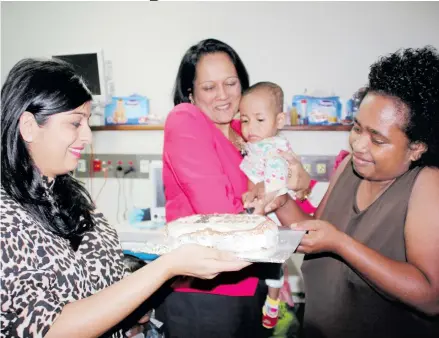  ?? Photos: Ministry of Health and Medical Services ?? General Practition­er and Medical Co-ordinator for Sai Prema Foundation, Dr Krupali Tappoo (left), Minister for Health and Medical Services Rosy Akbar holding baby Aqela Cirimaitog­a, 1, and Aqela’s mother Salote Vitiana.