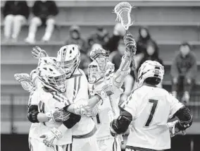  ?? KIM HAIRSTON/BALTIMORE SUN ?? Loyola celebrates a first-half goal against Johns Hopkins on Saturday. The Greyhounds won their home opener in dominant fashion before more than 4,000 fans.