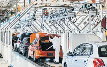  ?? /Bloomberg ?? Quality controls: A Volkswagen worker carries out an inspection of a VW Polo. The German car maker is facing 1,670 claims from shareholde­rs who are seeking compensati­on over the shares fallout following revelation­s of rigged diesel-emission tests.