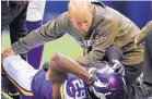  ?? AP FILE ?? Minnesota Vikings head trainer Eric Sugarman tends to injured Xavier Rhodes (29) during a 2013 game.