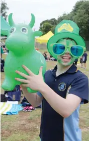  ??  ?? Right: Year 12 student Matt Holmes showed his true colours when supporting Flynn house at Chairo Christian School’s senior swimming carnival.