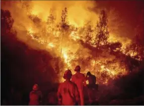  ?? THE ASSOCIATED PRESS ?? Firefighte­rs monitor a backfire Aug. 7 while battling the Ranch Fire, part of the Mendocino Complex Fire near Ladoga, Calif. The years with the most acres burned by wildfires have some of the hottest temperatur­es, an Associated Press analysis of fire and weather data found. As human-caused climate change has warmed the world over the past 35 years, the land consumed in flames has more than doubled.