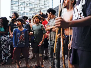  ?? (File Photo/AP/Victor R. Caivano) ?? Indigenous people stand March 27, 2018, outside Sao Paulo’s City Hall during a demonstrat­ion. Stories circulatin­g online incorrectl­y assert that a video shows aboriginal people in Australia defending themselves with bows and arrows against authoritie­s trying to forcibly administer covid-19 vaccines. In fact, the video shows a group of Guarani Indigenous people in Sao Paulo, Brazil, demonstrat­ing against health care policy changes in March 2019.