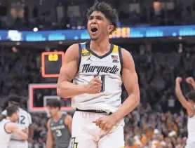  ?? MARK HOFFMAN / MILWAUKEE JOURNAL SENTINEL ?? Marquette guard Stevie Mitchell celebrates the win over Xavier on Wednesday at Fiserv Forum. Mitchell had six steals and three offensive rebounds to with 17 points.