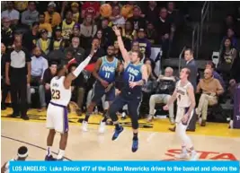  ??  ?? LOS ANGELES: Luka Doncic #77 of the Dallas Mavericks drives to the basket and shoots the ball against the Los Angeles Lakers at STAPLES Center in Los Angeles, California. — AFP