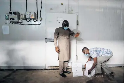  ?? PHOTO: REUTERS ?? ‘‘Momentous’’ . . . A worker prepares to store boxes of vaccines in a cold room as his country receives its first batch of Covid19 vaccines under the Covax scheme in Accra, Ghana, yesterday.