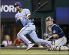  ?? RON JENKINS — GETTY IMAGES ?? The Texas Rangers' Marcus Semien doubles against the Seattle Mariners in the first inning Sunday, extending his hitting streak to 23.
